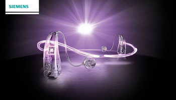 Binaurales Hörgerät binax im Scheinwerferlicht